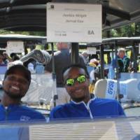 2 men in golf cart in blue